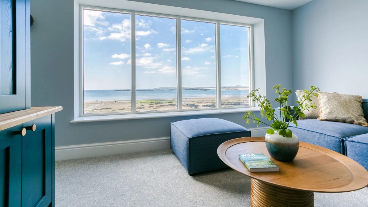 Beach terrace living room with a large window looking out to views of the sea