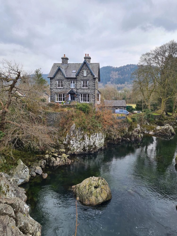 Bryn Afron - a three storey detached house by a river.