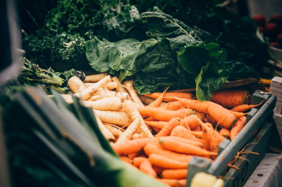carrots, parsnips and kale in a crate