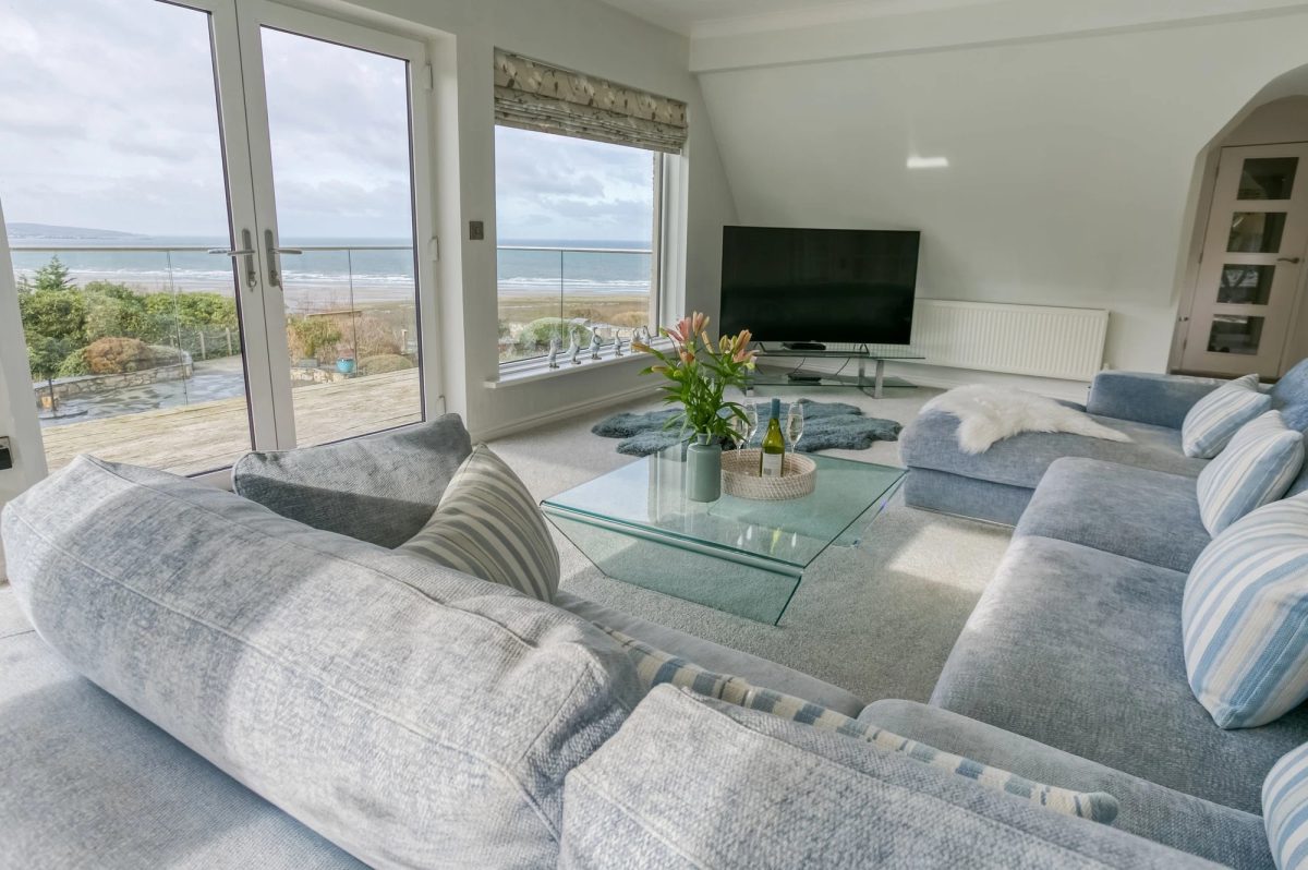 Gwynaeth Gwyn living room with L-shaped sofa and views out to sea