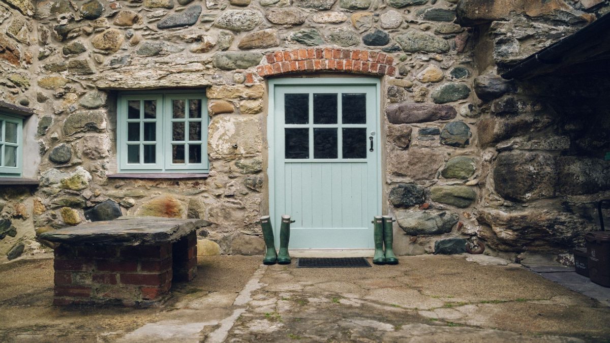 Bodfan Bach front door with wellies on the front.